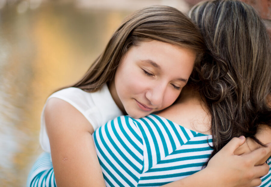 Mother and daughter hugging after therapy session